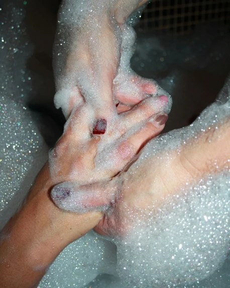 a couple of hands that are in some water