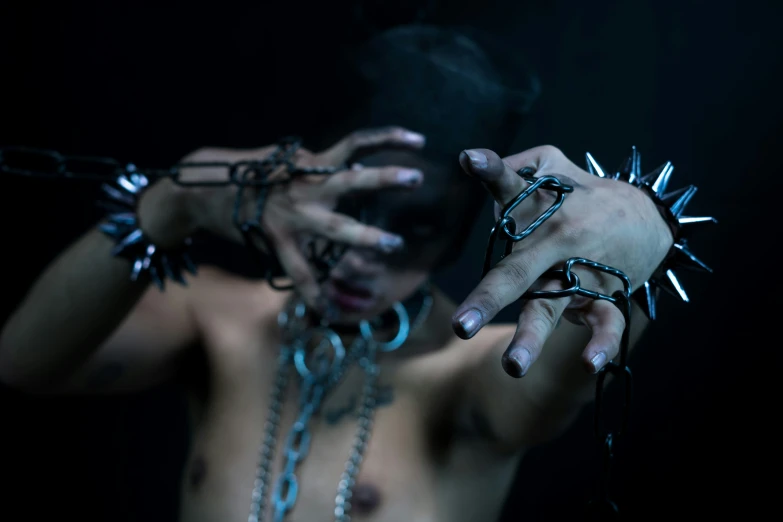 a woman holding her hands up with a chain around her neck