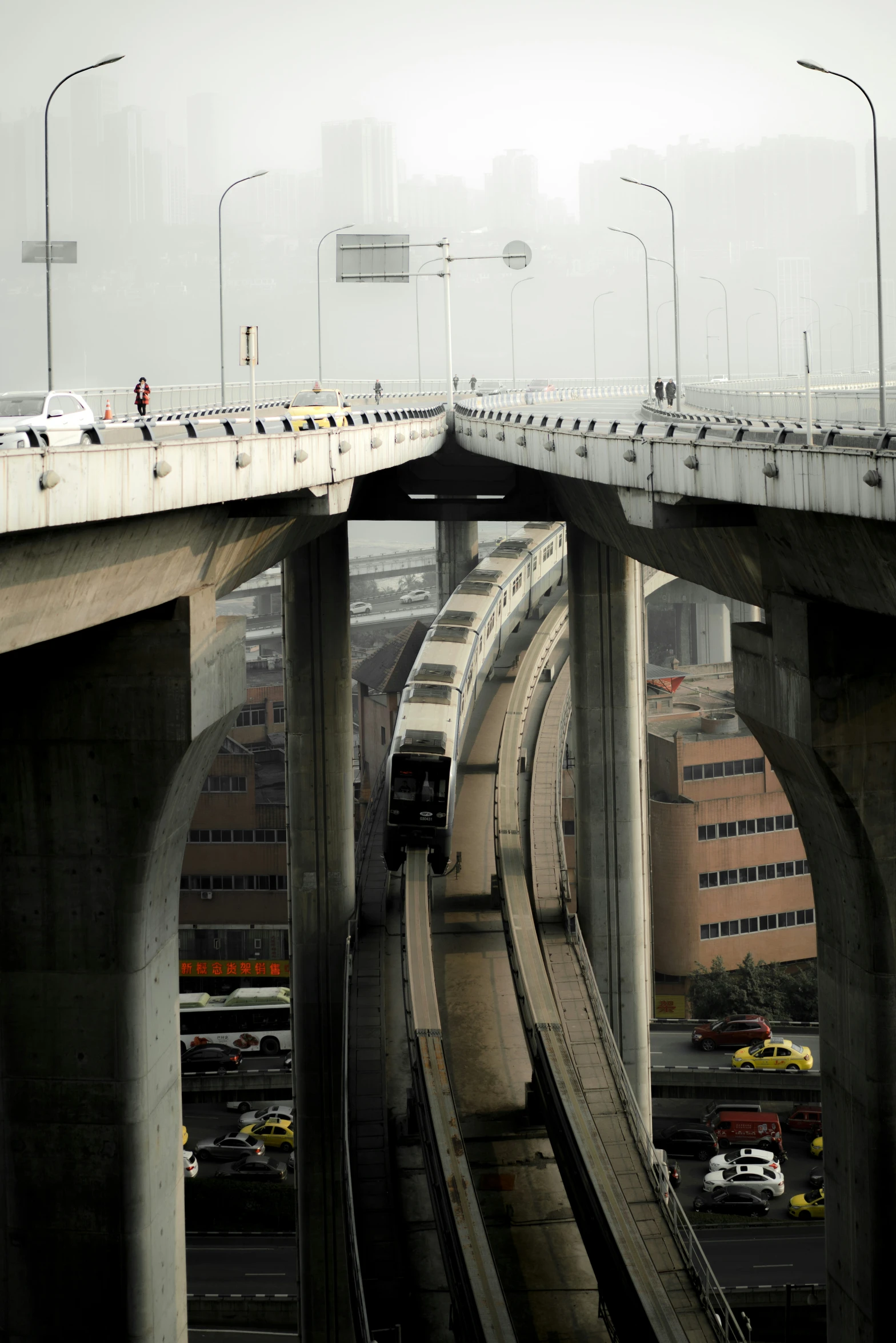 there is a large bridge with two trains coming up it