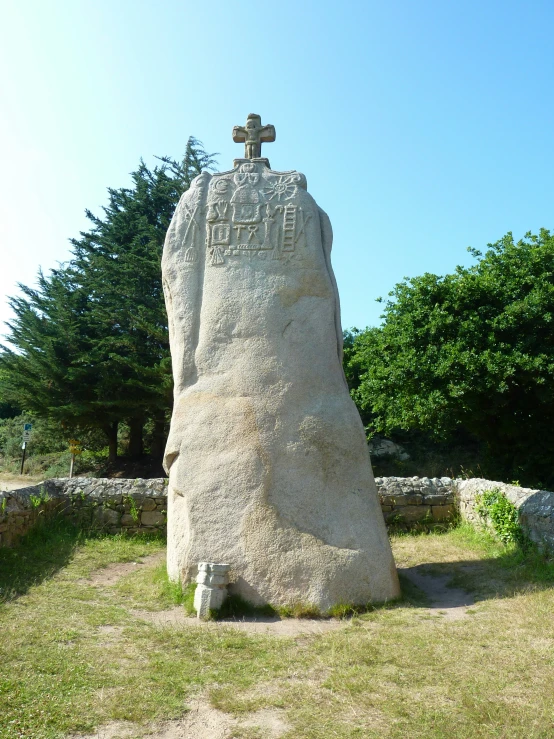 a stone with a cross on top of it