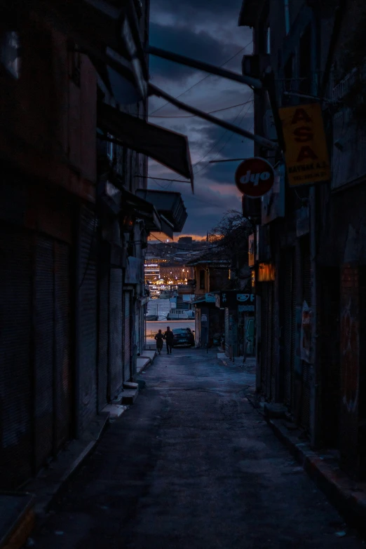 a dark street at night that has lights and signs