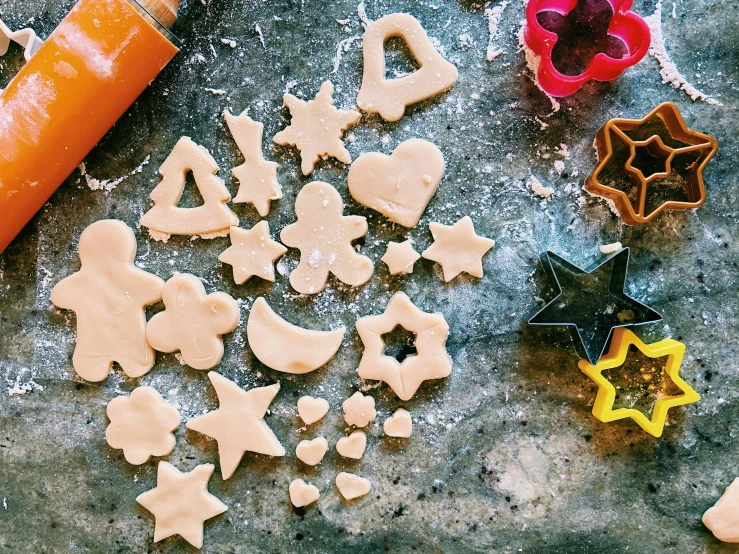 cookie shapes, with some cookie cutters and dough