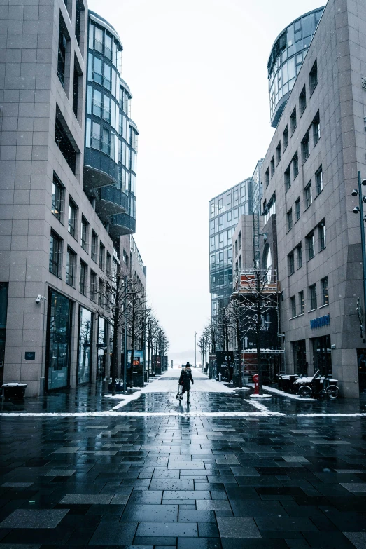 there are two people walking on a wet street