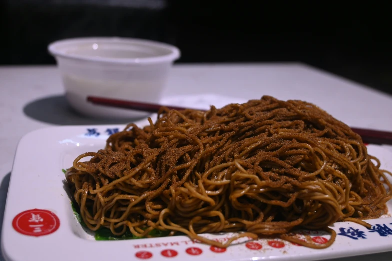 this dish of noodles with chopsticks is ready to be eaten