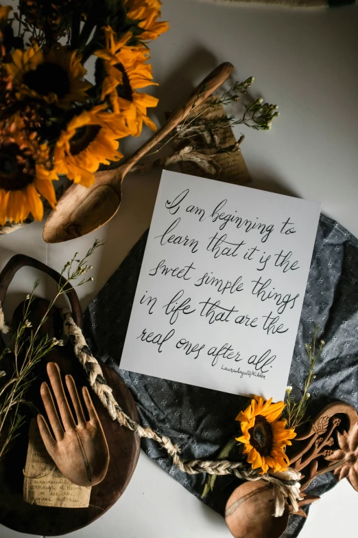 an opened envelope next to a wooden and rope tied around some pumpkins