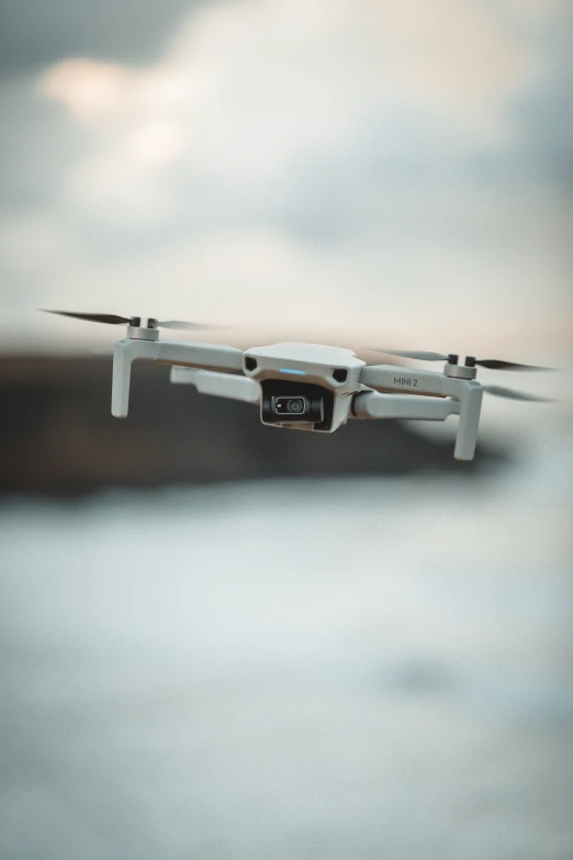 an aerial view of a white quad unmanned vehicle