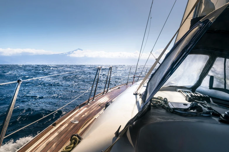 water splashing off the side of a sail boat in the open sea