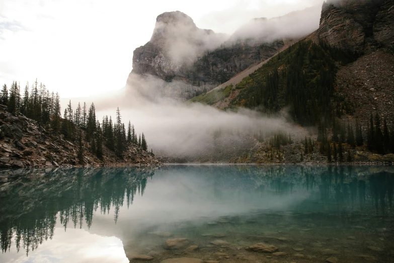 there is a mountain range in the distance near some lake