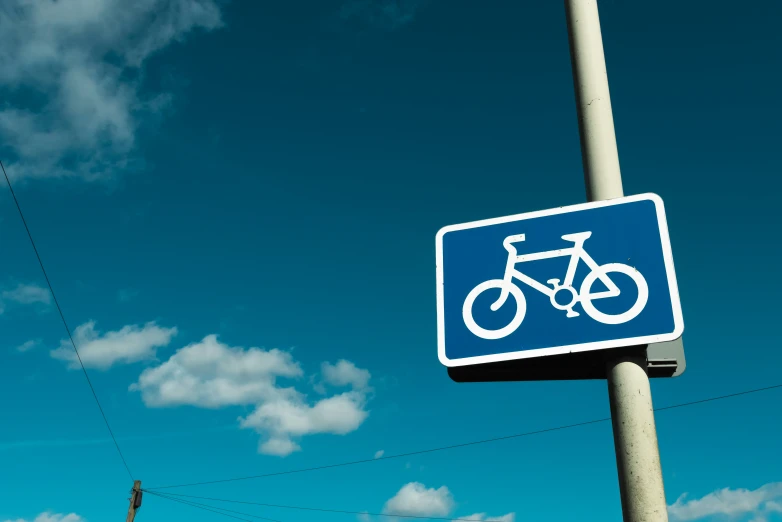 the street sign has a bicycle on it