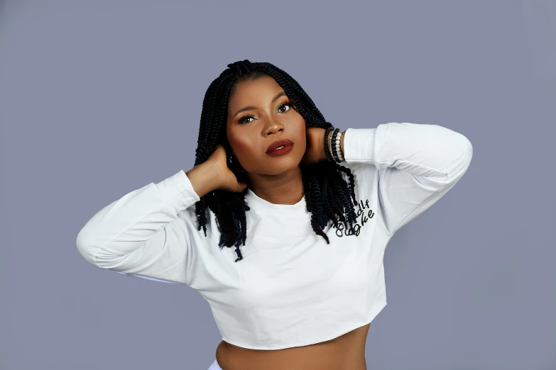 a black woman in white shirt posing with her hands on her head