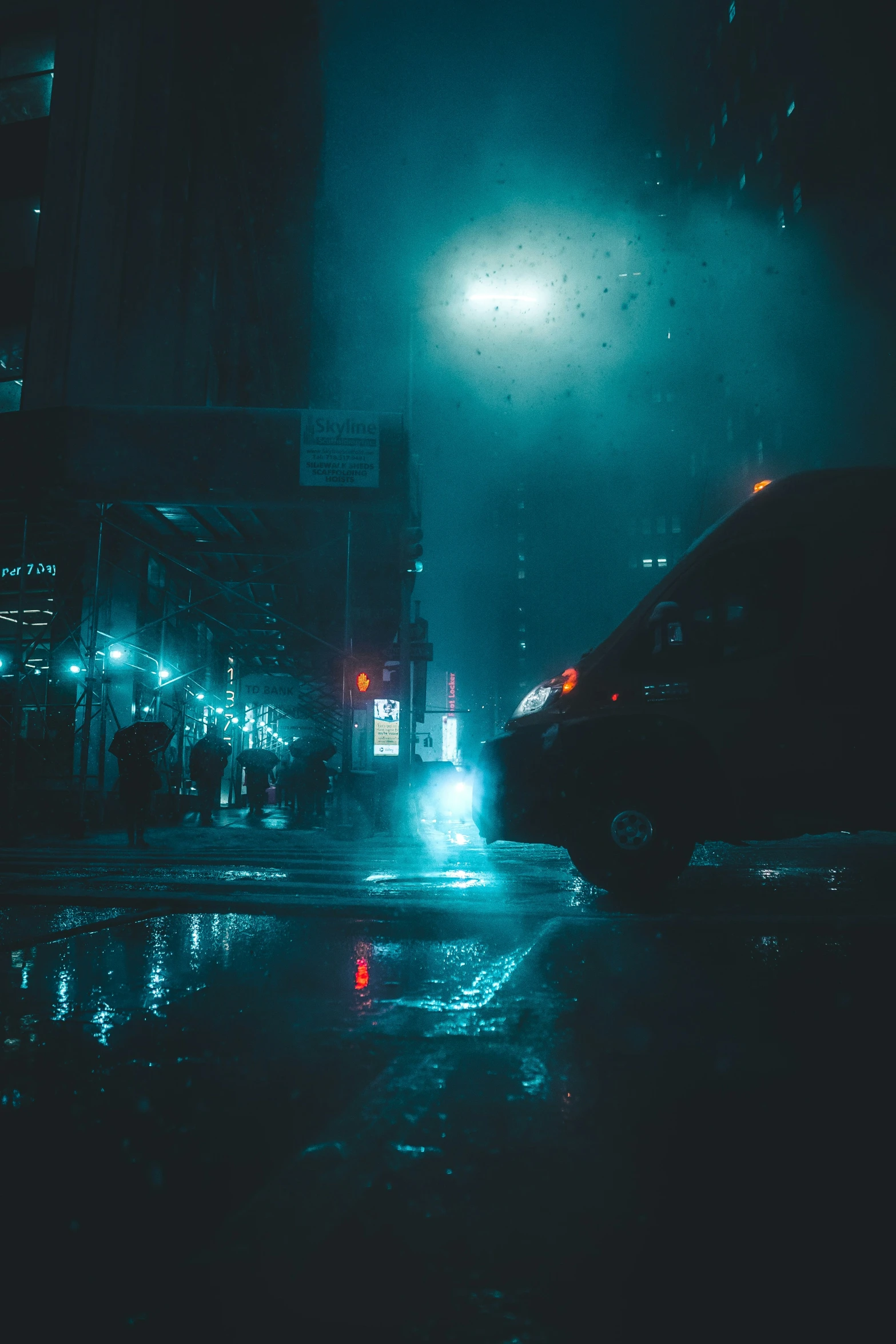 a street at night with cars and traffic lights