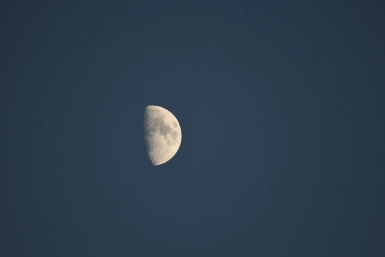 the moon is visible on a clear day