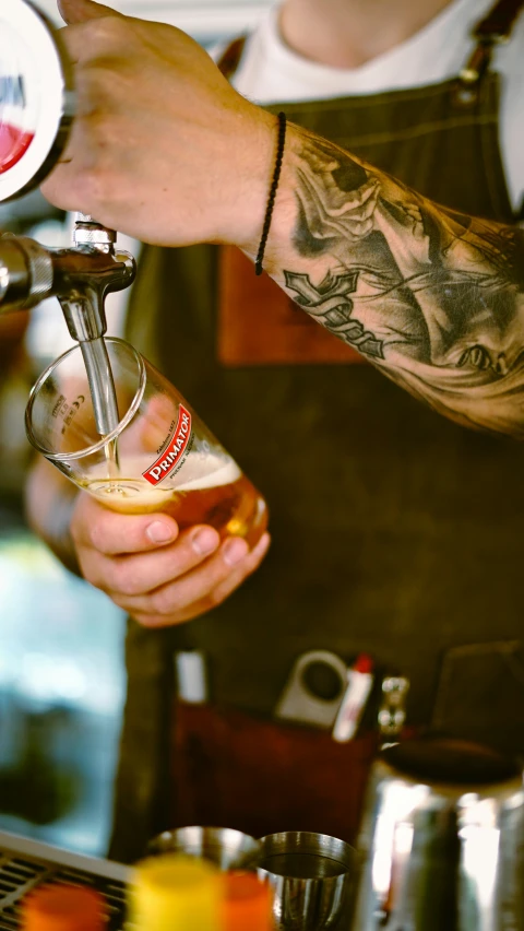 bartender adding beverage into cup of beverage being poured