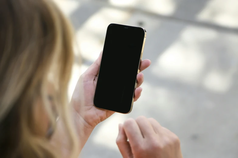 a close up of a person holding a cell phone