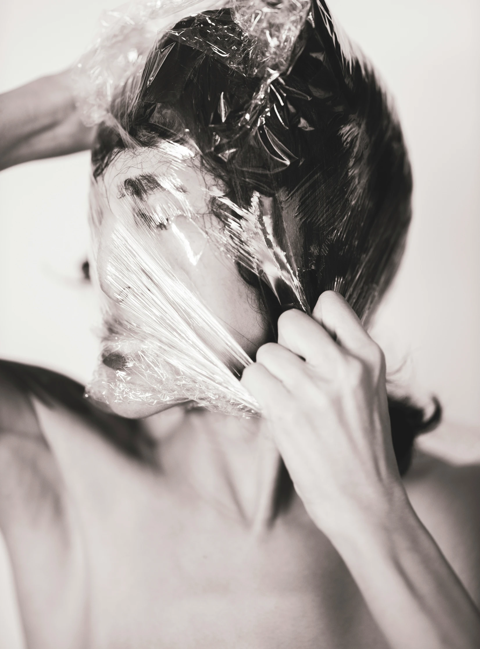 a man wiping down a plastic bag with scissors