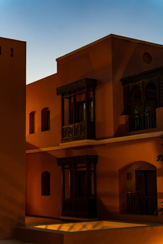 an orange building with lots of windows and balconies