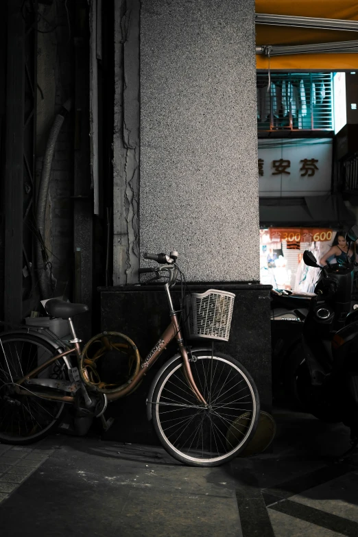 a bicycle sits on a curb in front of a building