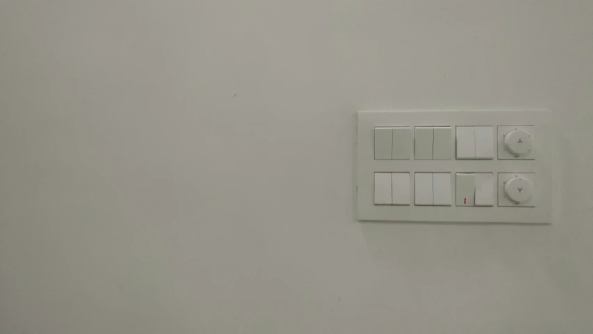 a small switch and a socket on a wall