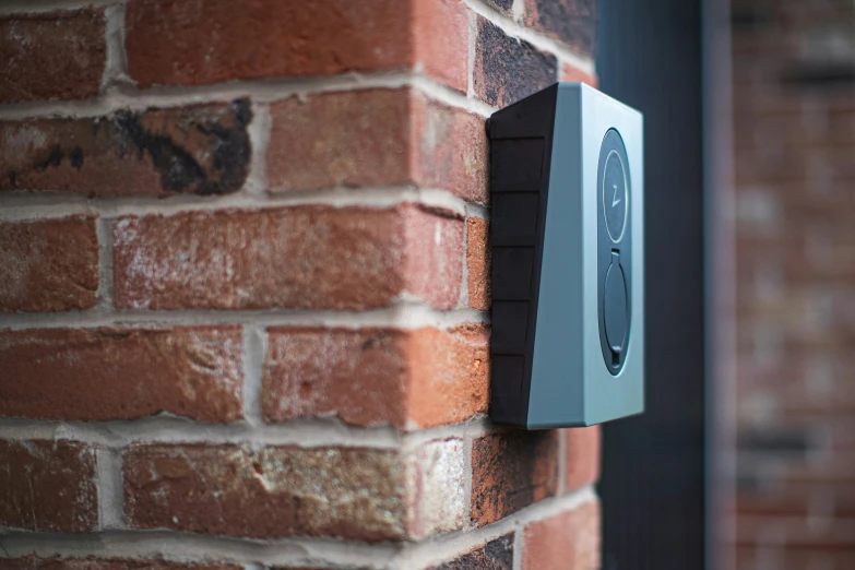 an exterior brick wall with a plaque that says