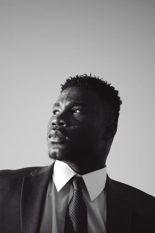 a man in a suit with a tie posing for the camera