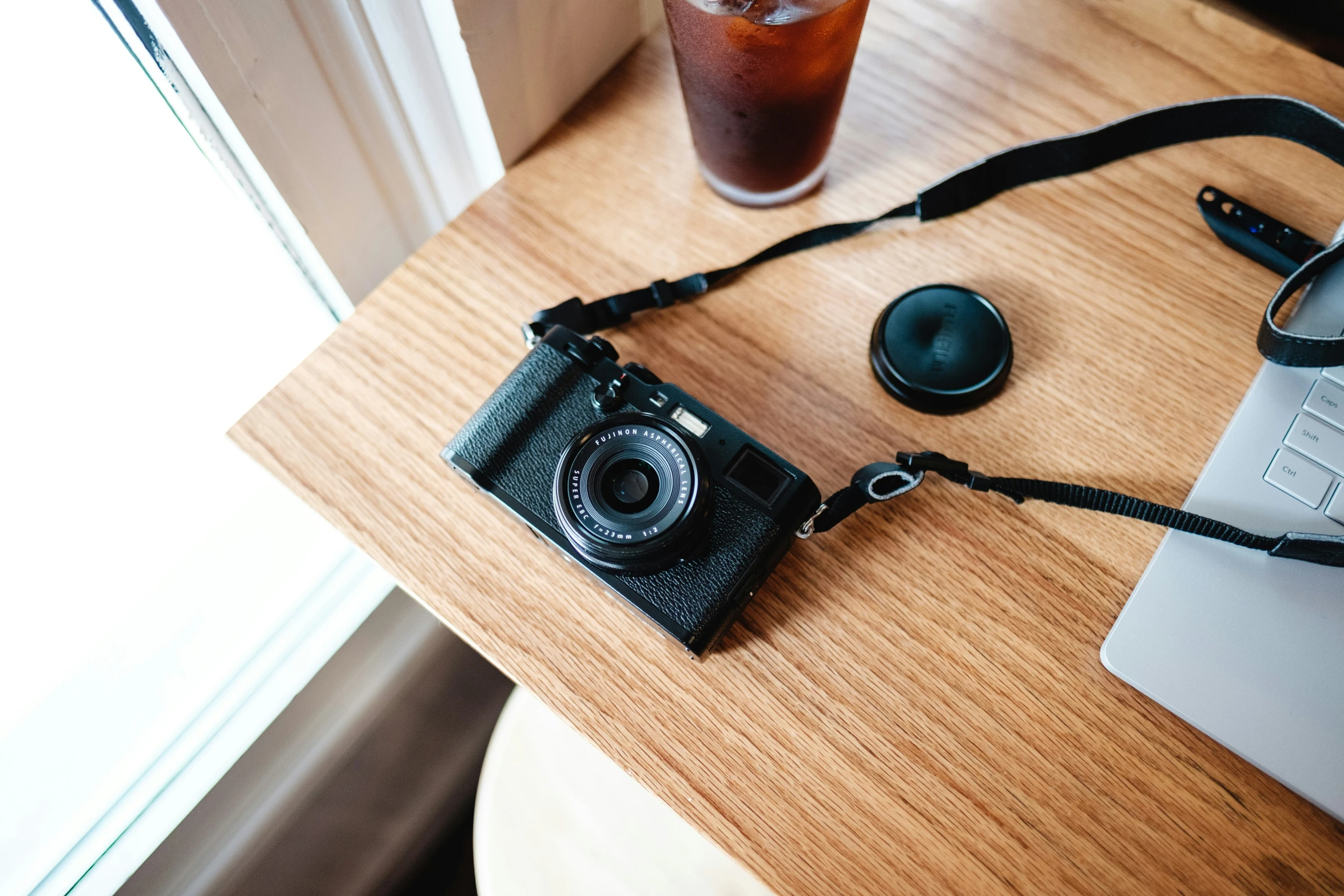 a camera and a glass on a desk