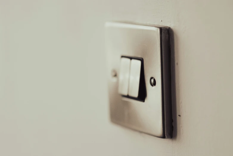 there is a light switch that has two outlets