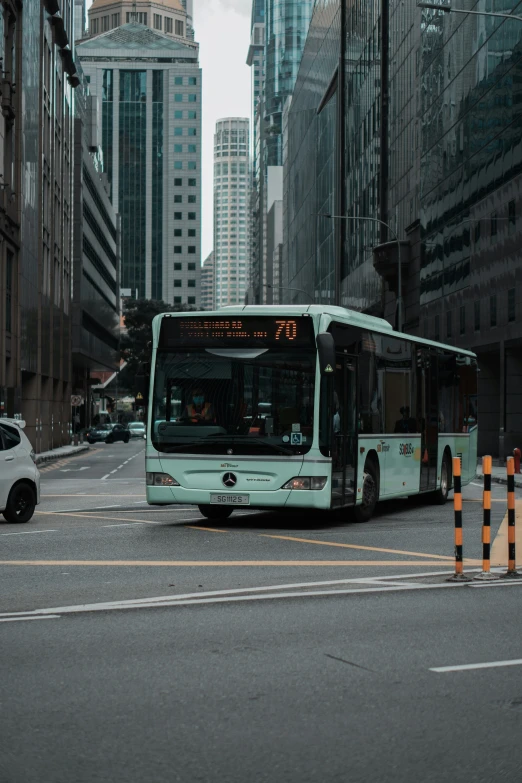 a bus driving down the street in front of tall buildings