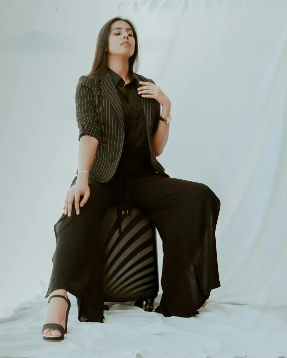 woman sitting on a chair wearing all black