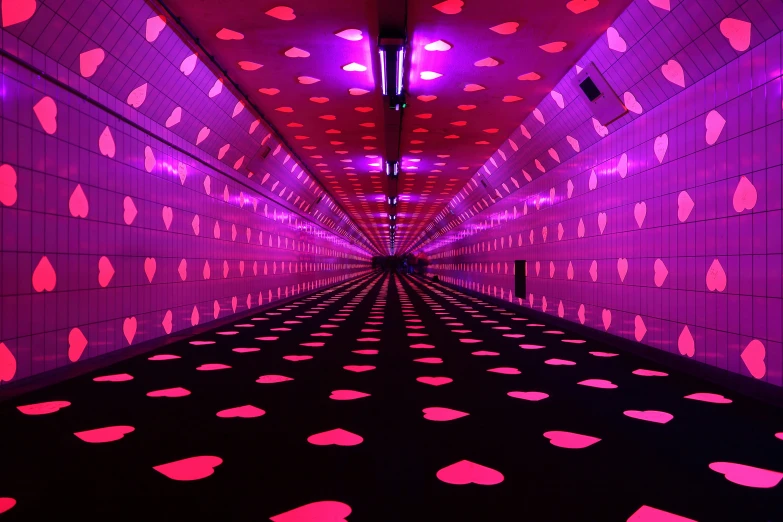 a very long and colorful room with lights on