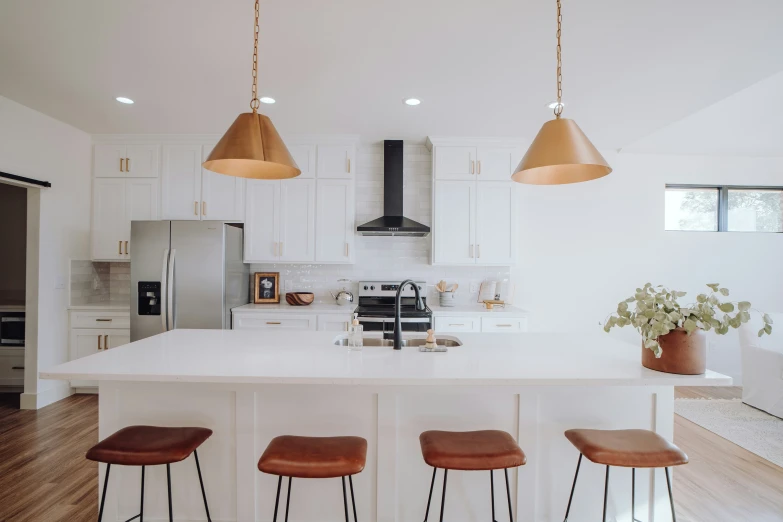 modern kitchen with an island and gold pendant lights