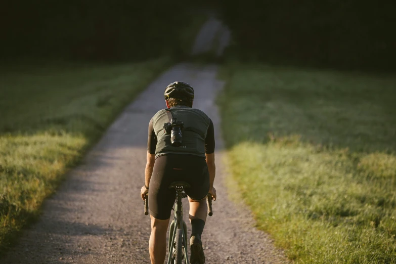 the person is riding on the bike down the path