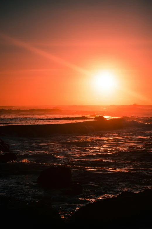 sunset showing just a light shine across a large body of water