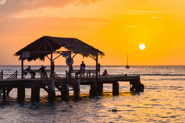 a pier at sunset on a tropical island