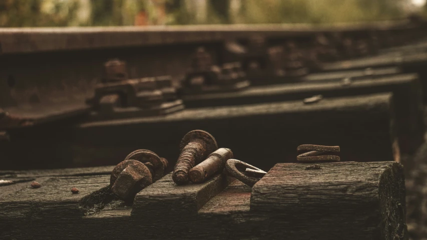 two train tracks with some rocks and chains