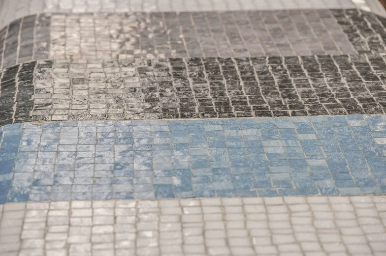 a view of the surface from below on a tiled sidewalk