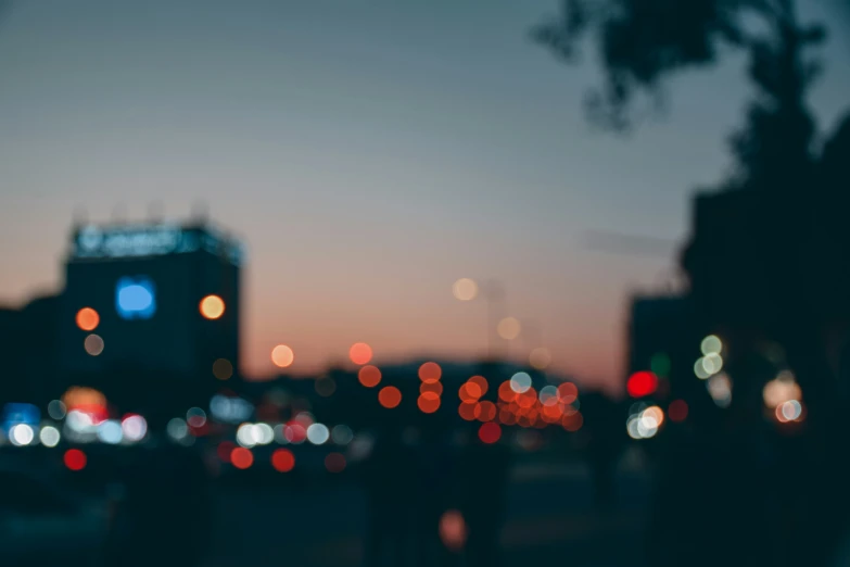 blurry picture of city street at dusk with traffic