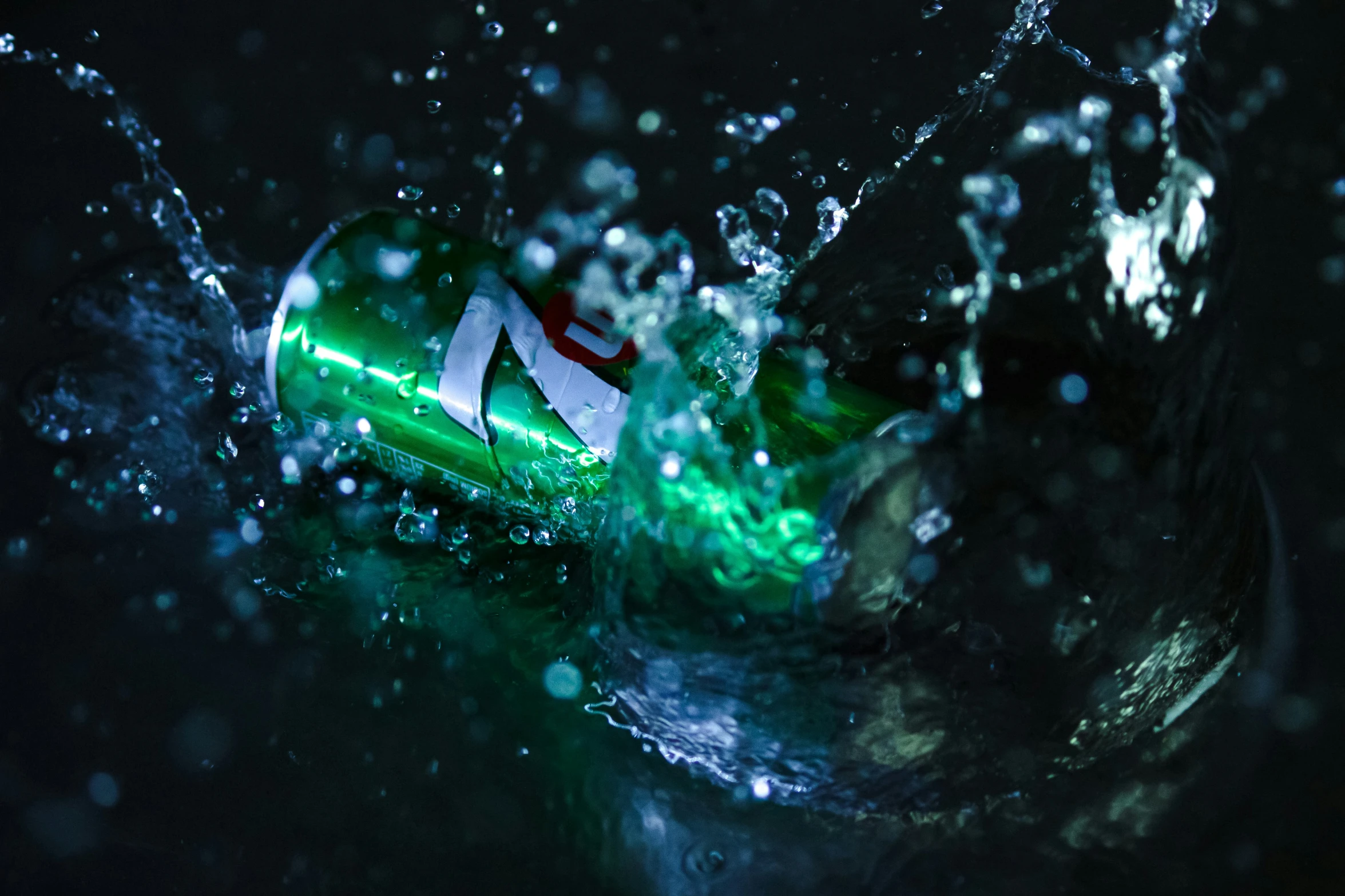 green bottle floating in a pool of water