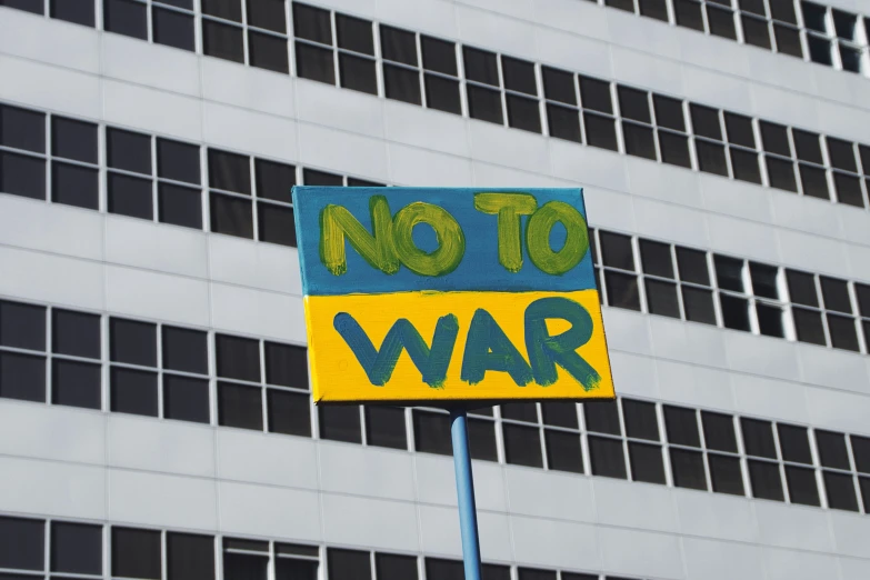 a sign with a no to war painted on it