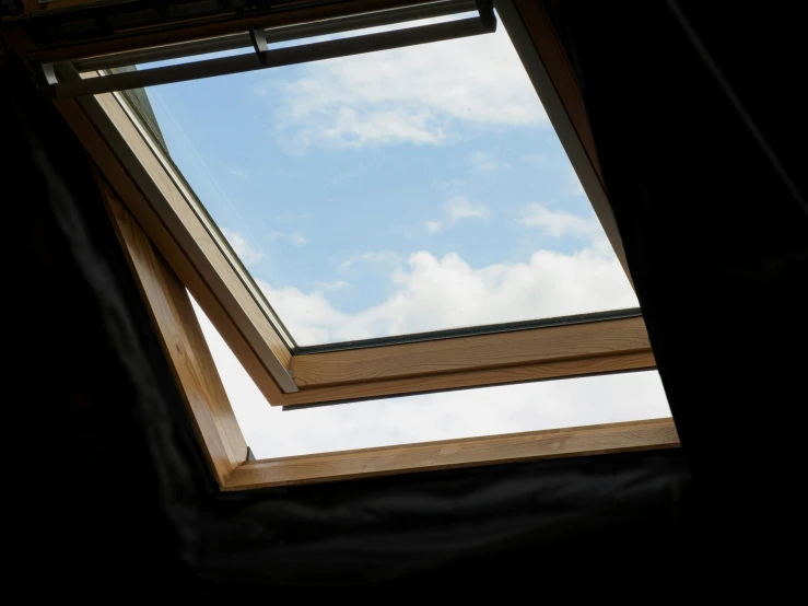 a bird perched on top of a wooden roof