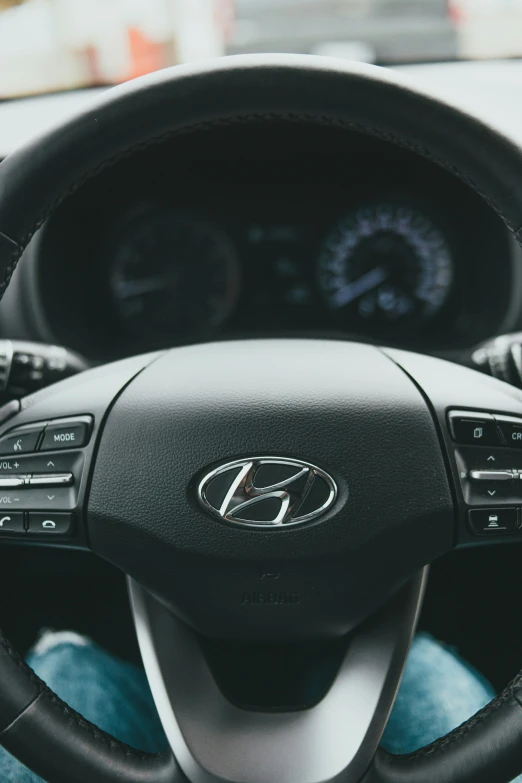 dashboard view of a car with the steering wheel