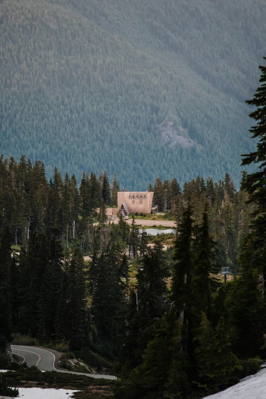 an old church perched among the trees is visible through the clouds