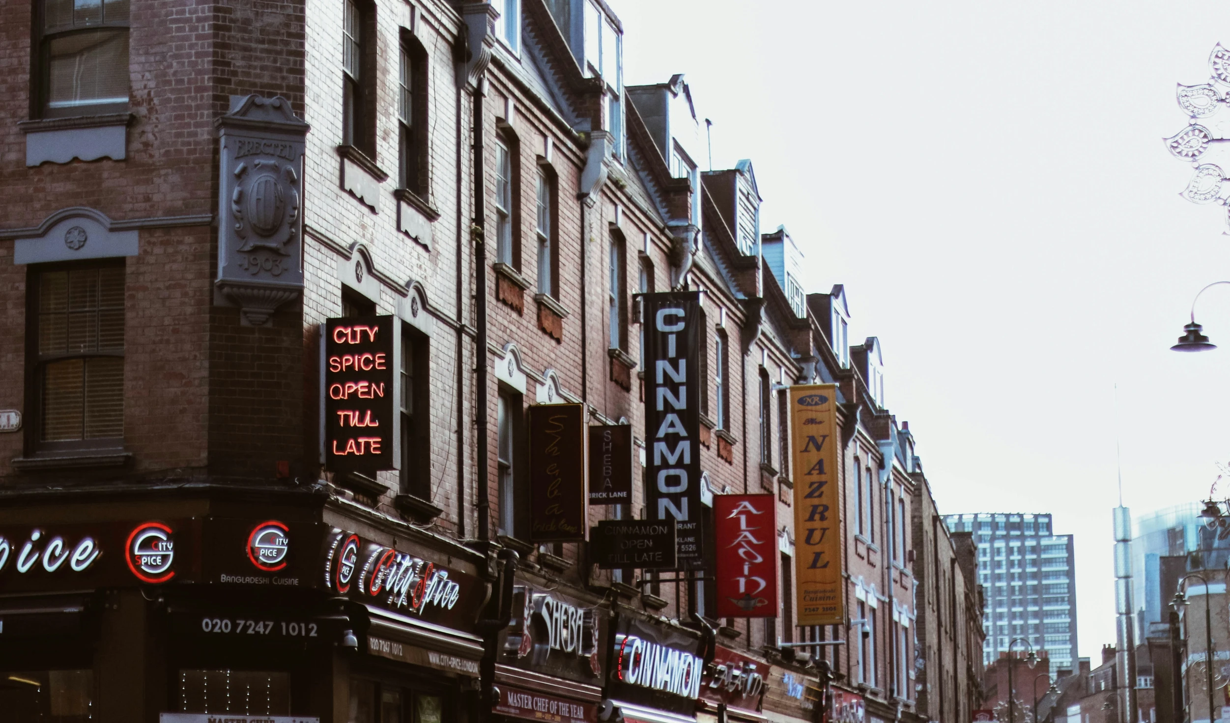 a very wide street with buildings in the distance