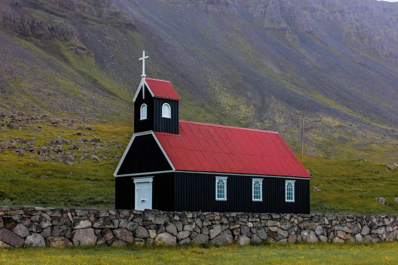 a church in the midst of mountains with stone walls