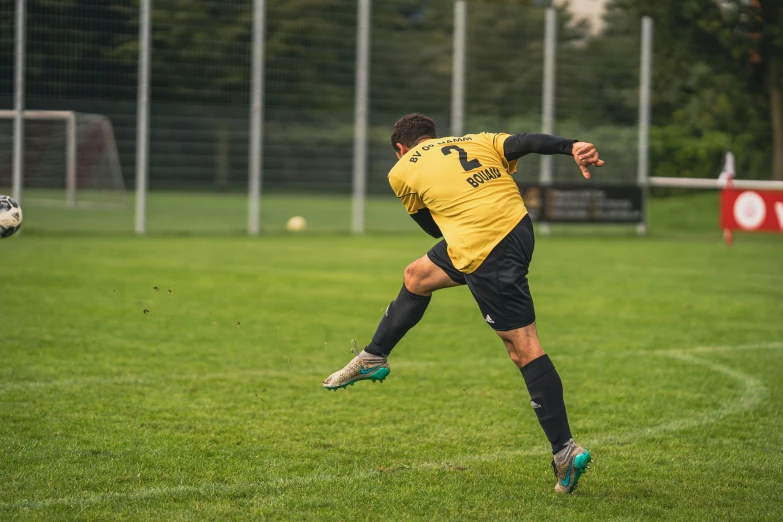 a man in black shorts kicking a soccer ball