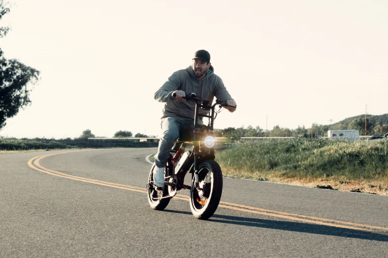 a man is riding a motorcycle down a street