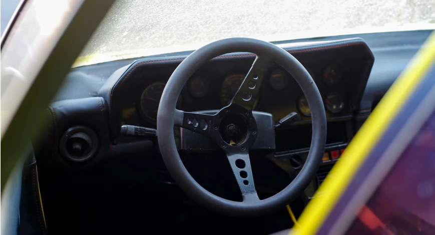 the steering wheel of a car with its seat down