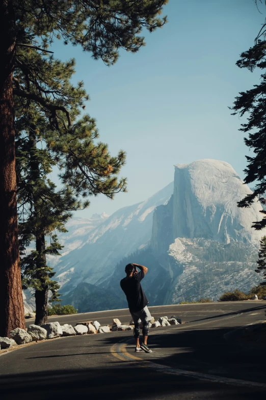 a man is taking a picture in the mountains