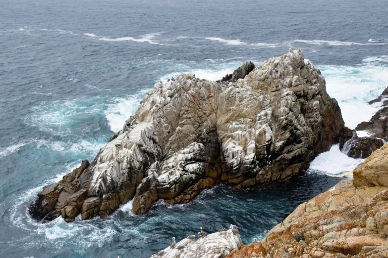 there is some very big rocks near the ocean