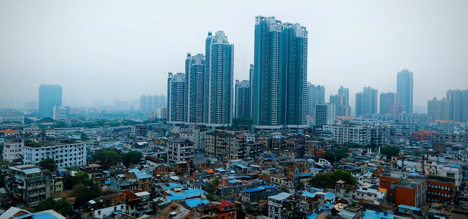 several large city buildings with skyscrs in the background