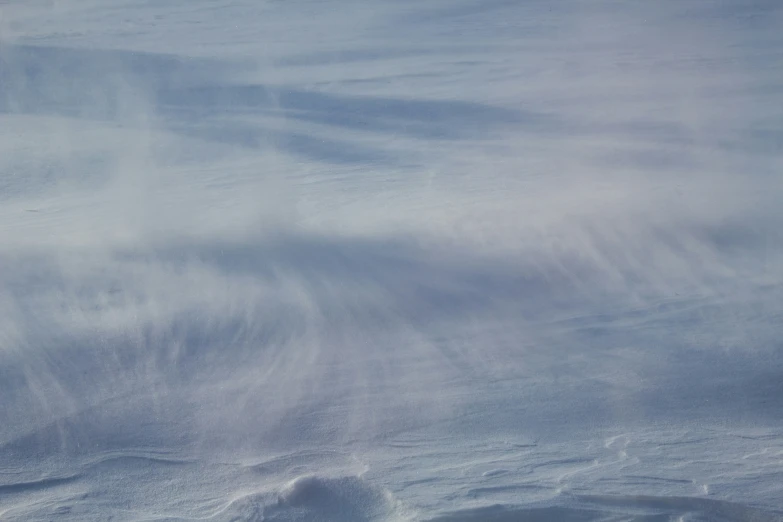 person walking down the slope, on their skis